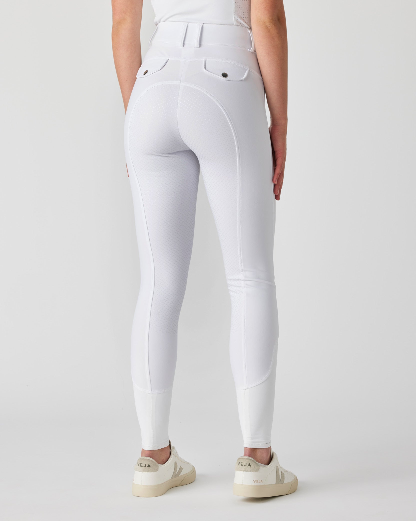 White riding breeches modelled by woman, rear view.